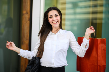 Beautiful young woman shopping bags outdoor in a city center