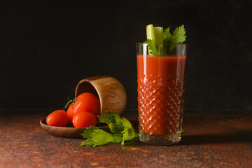 Glass of bloody mary with celery and tomatoes on table - obrazy, fototapety, plakaty