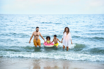 Fototapeta na wymiar Happy family swimming in sea