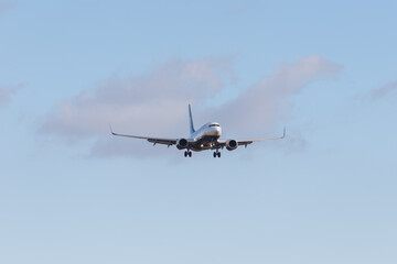 Naklejka na ściany i meble Boeing 737 landing on runway 27 at EMA airport - stock photo