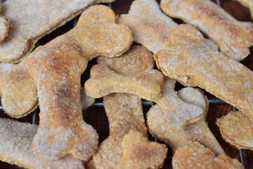 Homemade dog biscuits in the shape of paws. 