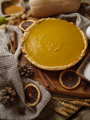 Festive composition - American pumpkin pie and decor. Halloween, Thanksgiving, New Years, Christmas, birthday, family gatherings and celebrations. Close-up.