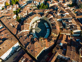 Aerial view of Piazza dell'Anfiteatro, a medieval square with cafè and market in Lucca old town, Tuscany, Italy. - obrazy, fototapety, plakaty