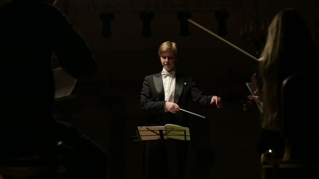 leader of the symphony orchestra. Young conductor leads the orchestra