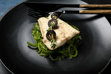 Plate of delicious sea bass fish on table, closeup