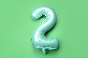 Balloon in shape of figure 2 on green background