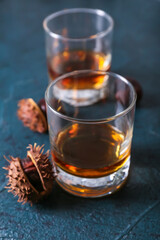 Glasses of chestnut whiskey on black background