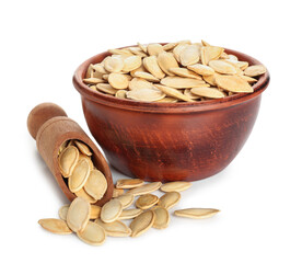 Bowl and scoop with natural pumpkin seeds on white background