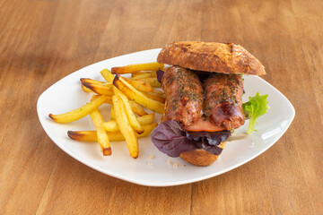 Argentine choripan porteño recipe with homemade chips and lettuce on white plate