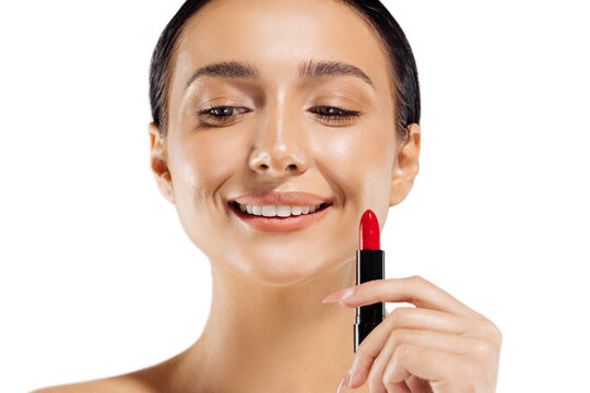 Beautiful woman with lipstick, photo of a brunette with red lipstick on a white background, woman applying lipstick
