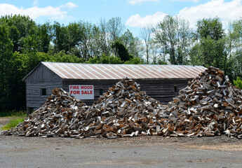 Large piles of split firewood for sale.