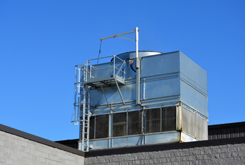 Industrial cooling tower mounted on a roof top.