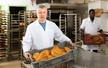 Successful baker during daily work in bakeshop. High quality photo