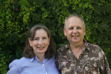 Faces of a happy couple in casual clothes looking toward  the camera