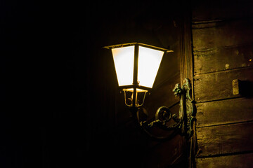 Lighted vintage street lantern at night