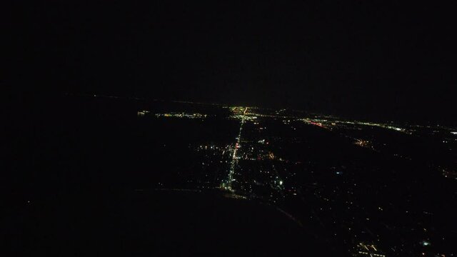 Airplane Banking Right Cockpit View Over City Skyline At Night