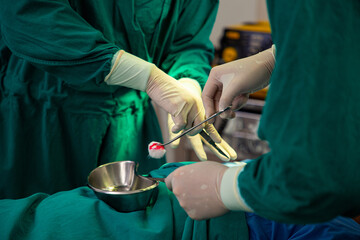 Medical team using knife for open  wound of patient.