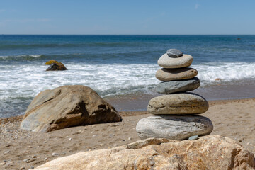 peaceful stack of rocks on a beach with waves