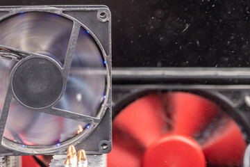spinning 90 mm pc fan close-up with thick layer of dust and flying airborne dust particles