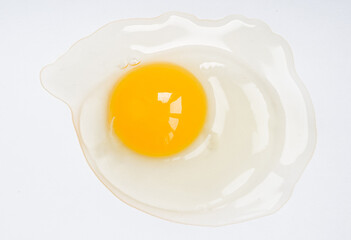 raw chicken egg without shell on a white background, top view