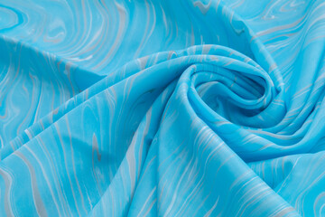 Blue top view of base color silk, fabric with blue marble pattern silk, wavy, spiral, crease, swirl, backdrop, cloth background, have copy space for text