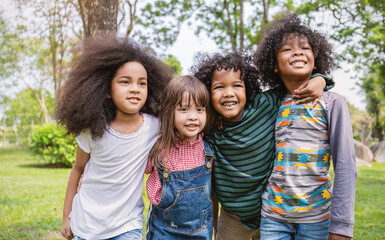 Portrait of four children having good time outdoor park, black caucasian children student together playground background. Home school education diversity multicultural community. Back to school.