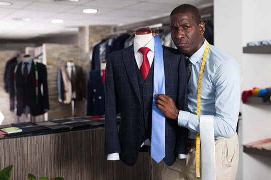 Portrait of African-american man customer choosing business style tie in the shop. High quality photo