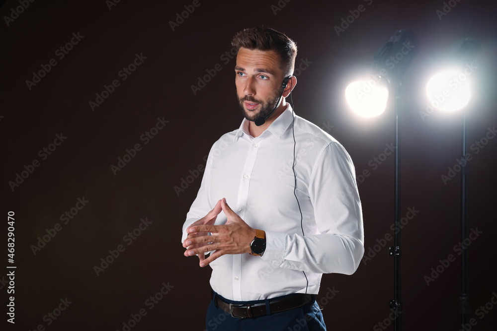 Wall mural motivational speaker with headset performing on stage