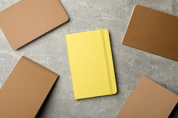 Different planners on grey table, flat lay