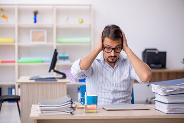 Young male employee working in the office