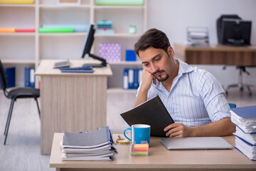 Young male employee working in the office