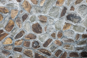 The texture of a stone wall made of stones of different sizes. Old castle stone wall texture background