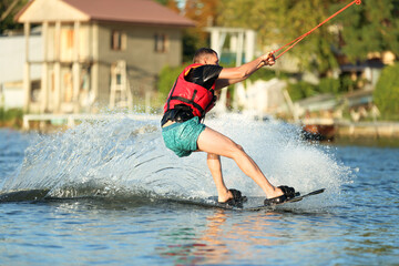 Man wakeboarding on river. Extreme water sport