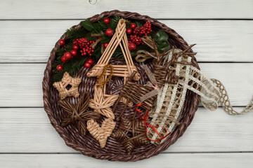 Basket with Christmas decorations. Wicker toys.