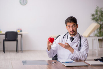 Young male doctor cardiologist working in the clinic