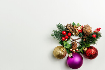 Fototapeta na wymiar Pine Cone with a bell and colorful Christmas ball on white background