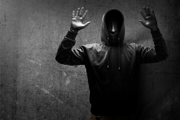 A criminal man in a hidden mask raised a hand for arrested