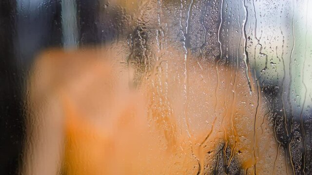 Woman Takes Shower Behind Water Drops Flowing Down On Glass