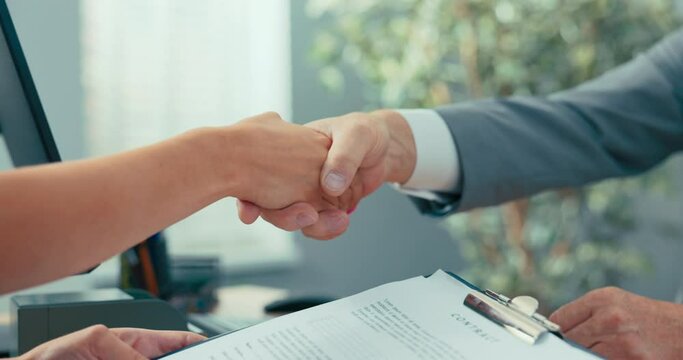 Job interview in company office, contract conclusion, handshake, congratulations, thank you, greeting, goodbye, hand of older man and young well-groomed woman