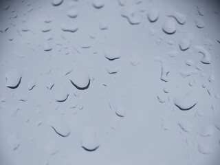 Drops of water drain on the window glass. A rainy day.