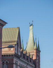 Obraz premium Facade and Cooper Roof of a gothic brick building a sunny autumn day in Stockholm