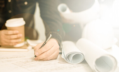 Architect working on blueprint. Architects workplace - architectural project, blueprints, ruler, calculator, laptop and divider compass. Construction concept. Blue print is fake only for stock photo.