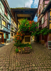 Fototapeta na wymiar Street in Eguisheim, one of the prettiest villages in France. Equishiem is in the Southern end of Alsace wine route.