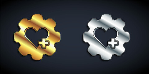 Gold and silver Heart with a cross icon isolated on black background. First aid. Healthcare, medical and pharmacy sign. Long shadow style. Vector