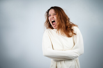 Obraz premium Close-up portrait of insane woman in straitjacket on white background.