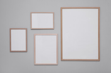 Empty frames on grey wall. Mockup for design