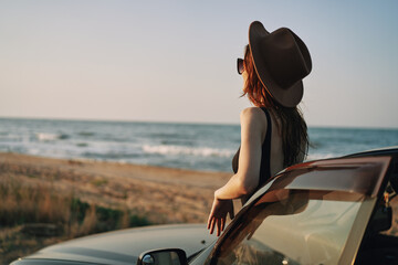 pretty woman in sunglasses near the car on the beach travel lifestyle