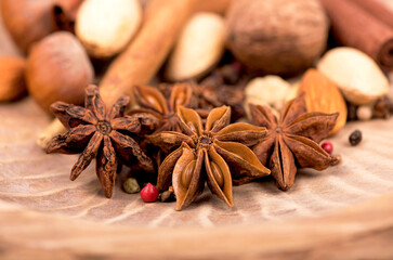 Traditional Christmas spices - Star anise with cinnamon and cloves on dark rustic wooden background