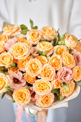 Beautiful bouquet of mixed flowers in woman hand. Floral shop concept . Beautiful fresh cut bouquet. Flowers delivery