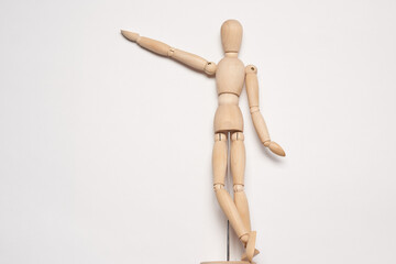 wooden mannequin posing on light background toy object